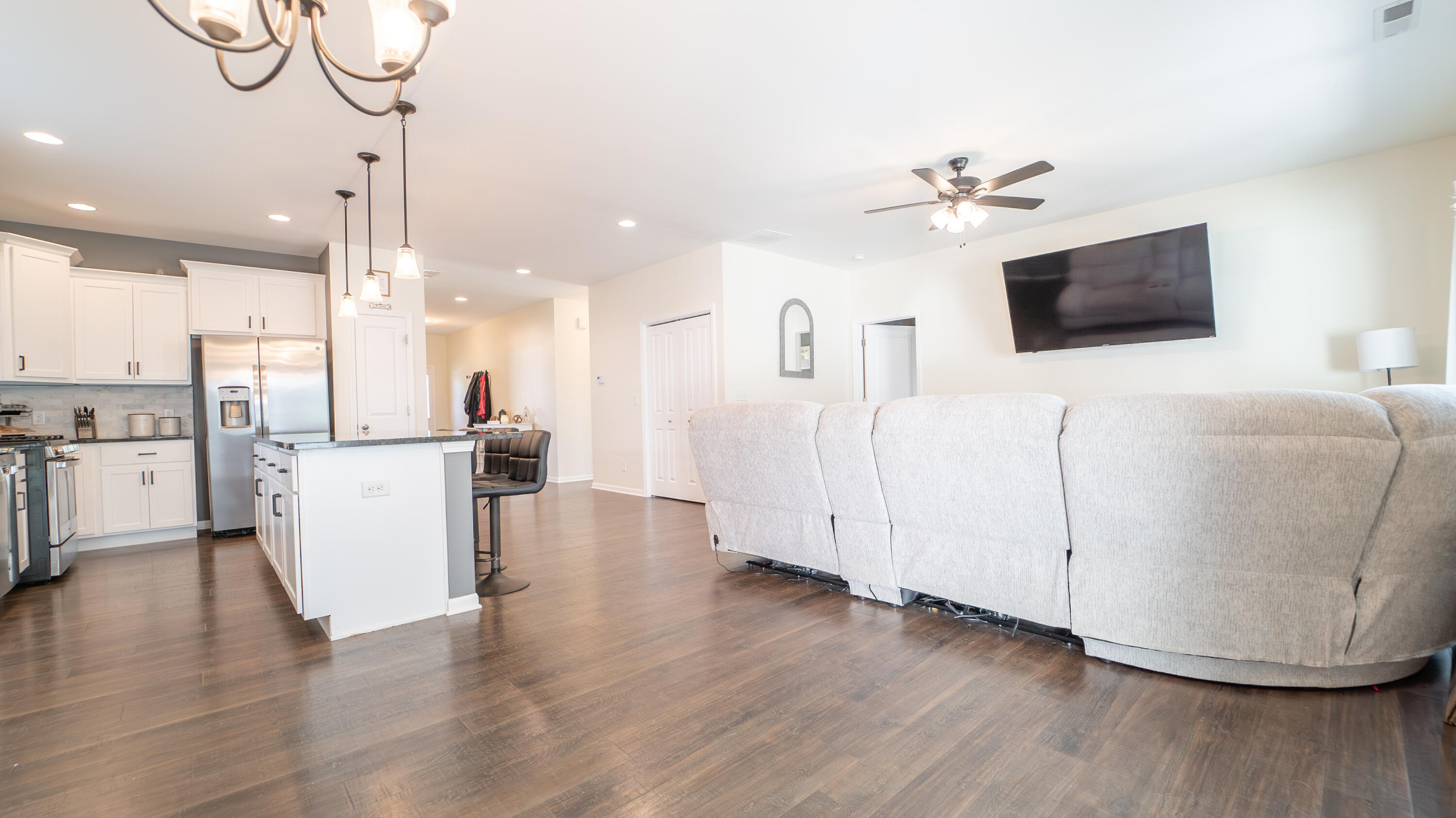 538 Emerald Drive Chesterton, IN 46304 - Photo 13 of 25 a view of a living room and kitchen with furniture wooden floor and a large window