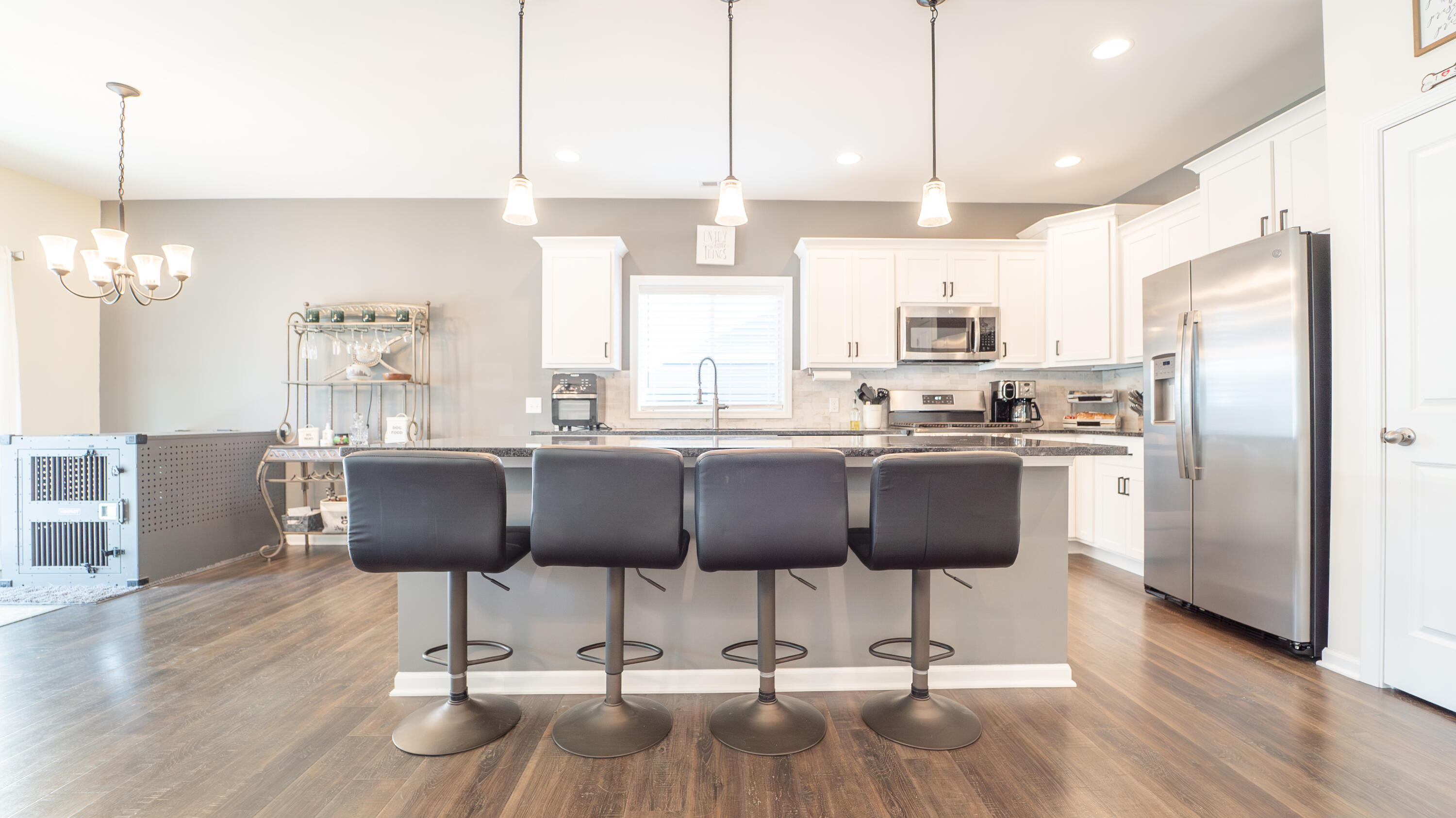 538 Emerald Drive Chesterton, IN 46304 - Photo 8 of 25 a kitchen with stainless steel appliances granite countertop a refrigerator a stove a sink dishwasher and a chairs with wooden floor