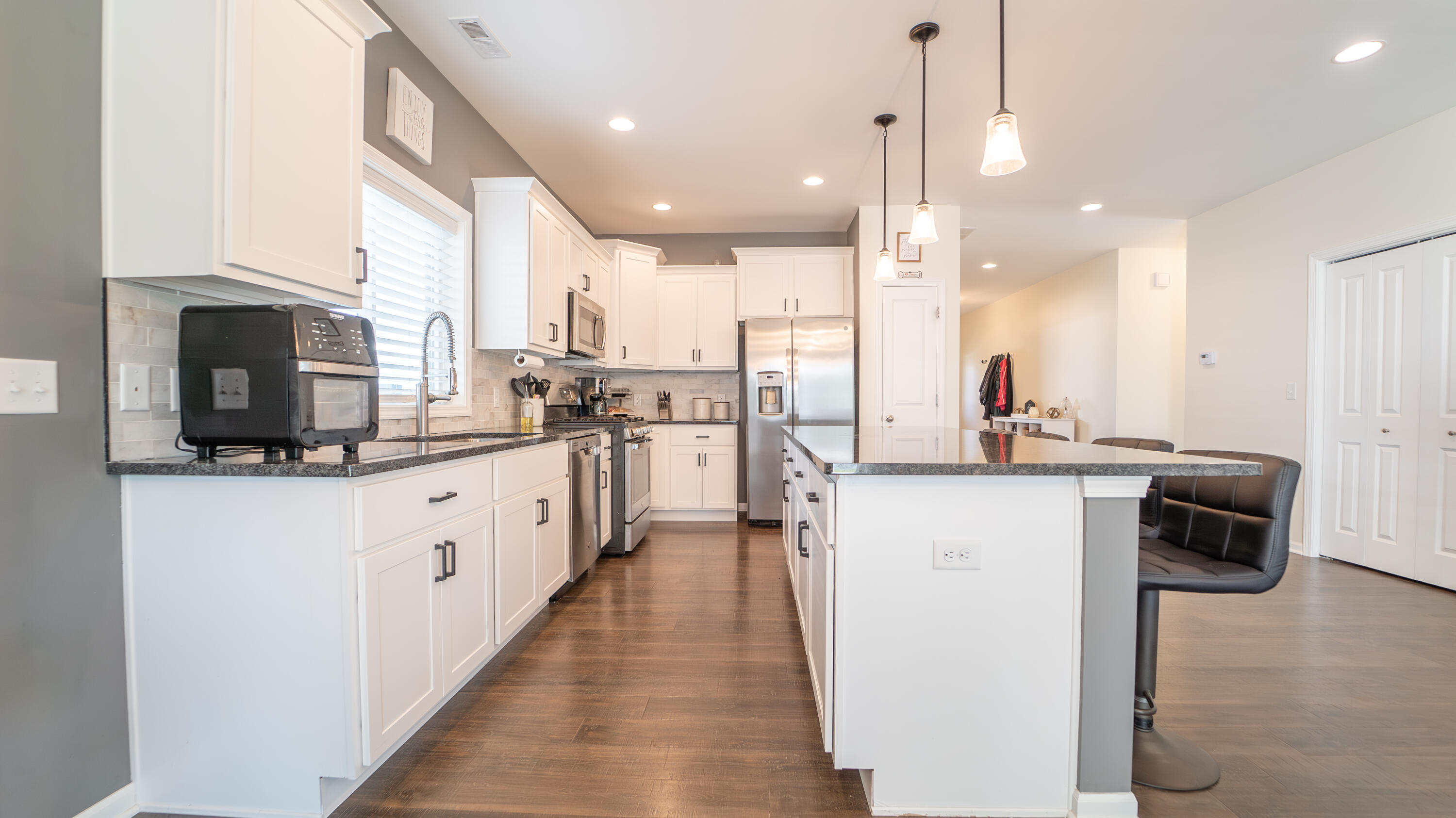 538 Emerald Drive Chesterton, IN 46304 - Photo 10 of 25 a kitchen with kitchen island granite countertop a sink appliances cabinets and a counter top space