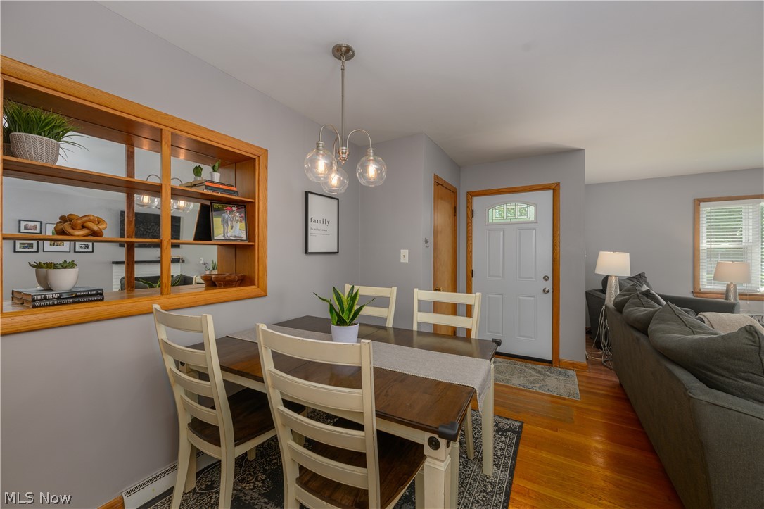 1243 Garman Road Akron, OH 44313 - Photo 11 of 21 Dining area with a notable chandelier and hardwood / wood-style flooring
