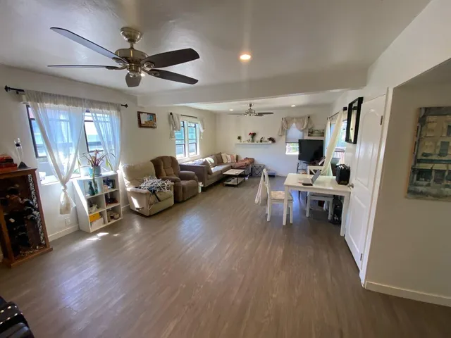 a living room with furniture and a wooden floor