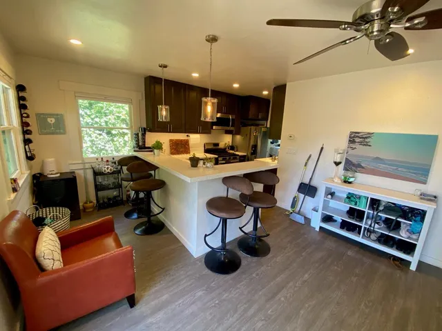 a view of a livingroom with furniture and a window