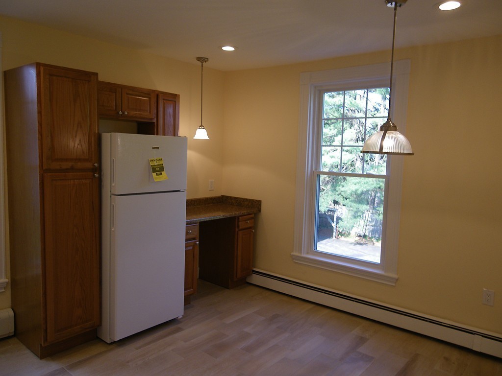 63 Oak Street, Unit B Needham, MA 02492 - Photo 3 of 8 a kitchen with refrigerator and window