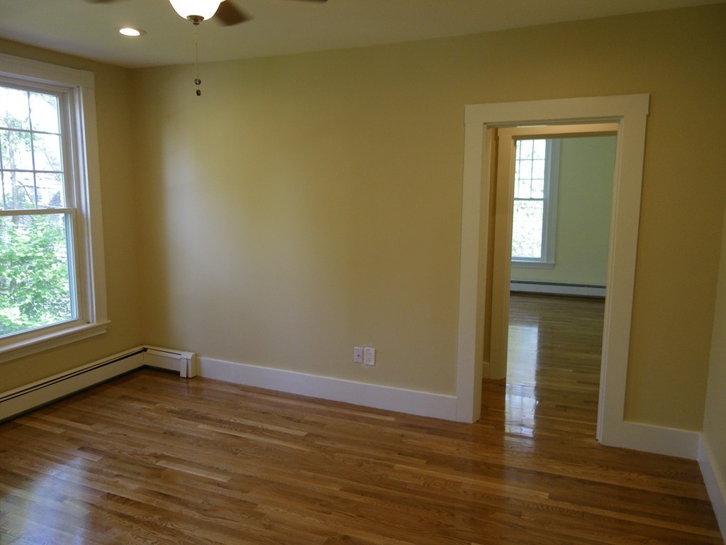 63 Oak Street, Unit B Needham, MA 02492 - Photo 5 of 8 a view of empty room with wooden floor and fan