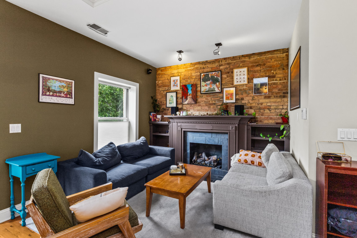 4635 North Malden Street, Unit 3S Chicago, IL 60640 - Photo 3 of 20 a living room with furniture and a fireplace