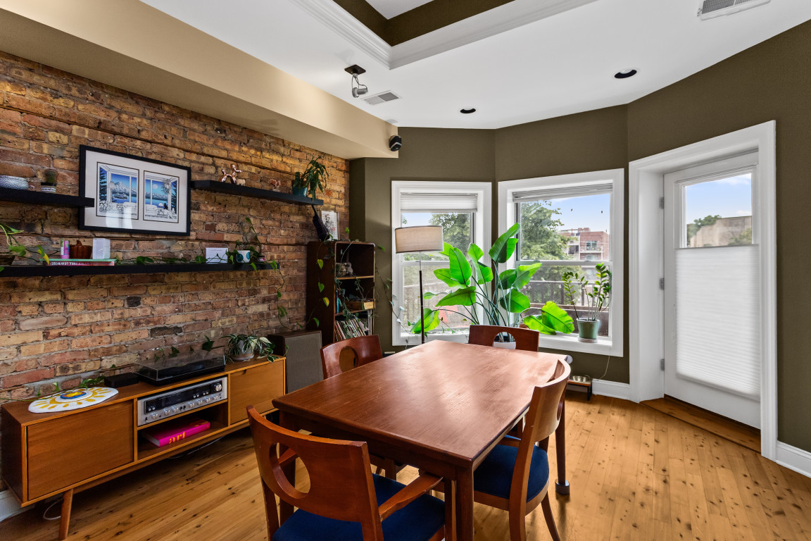 4635 North Malden Street, Unit 3S Chicago, IL 60640 - Photo 6 of 20 a view of a dining room with furniture and a potted plant