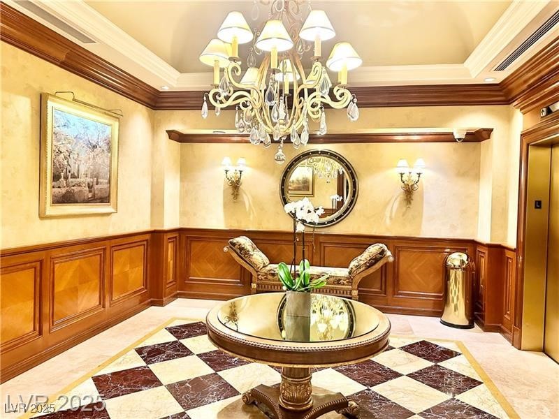 2857 Paradise Road, Unit 2103 Las Vegas, NV 89109 - Photo 54 of 55 Unfurnished room featuring a chandelier, wainscoting, ornamental molding, and visible vents