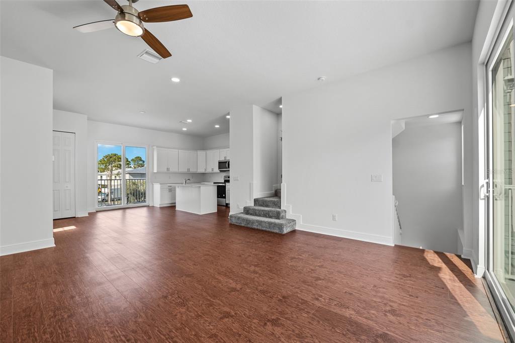 5732 Biscayne Court, Unit 1 New Port Richey, FL 34652 - Photo 11 of 48 a view of empty room with wooden floor and window