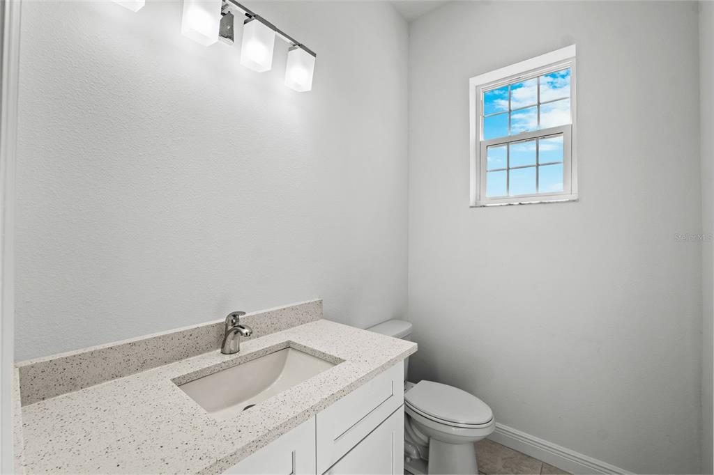 5732 Biscayne Court, Unit 1 New Port Richey, FL 34652 - Photo 12 of 48 a bathroom with a sink toilet and a mirror