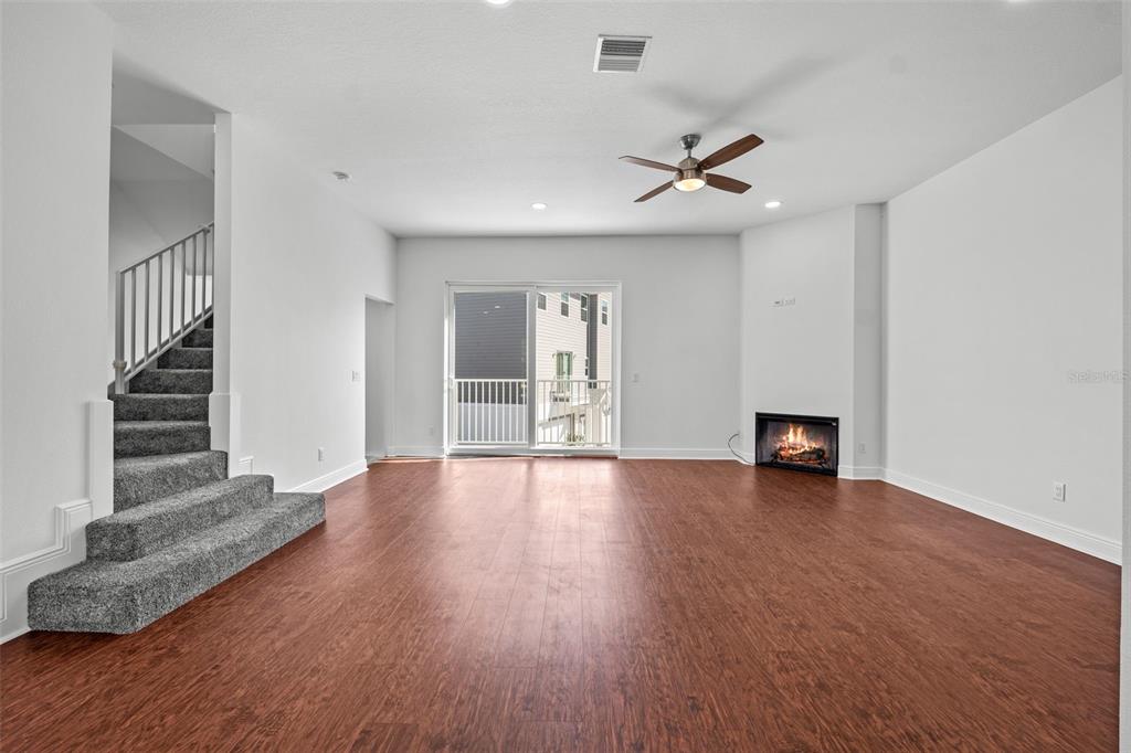 5732 Biscayne Court, Unit 1 New Port Richey, FL 34652 - Photo 5 of 48 wooden floor in an empty room with a window