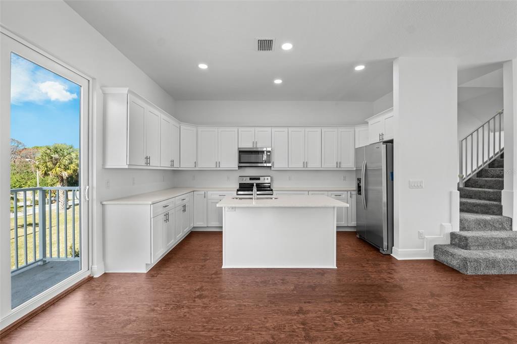 5732 Biscayne Court, Unit 1 New Port Richey, FL 34652 - Photo 8 of 48 a kitchen with stainless steel appliances granite countertop a stove a sink and a refrigerator