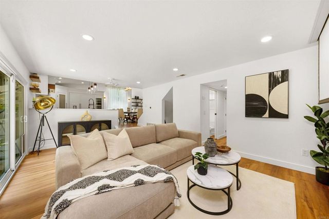 a view of livingroom with furniture wooden floor and windows