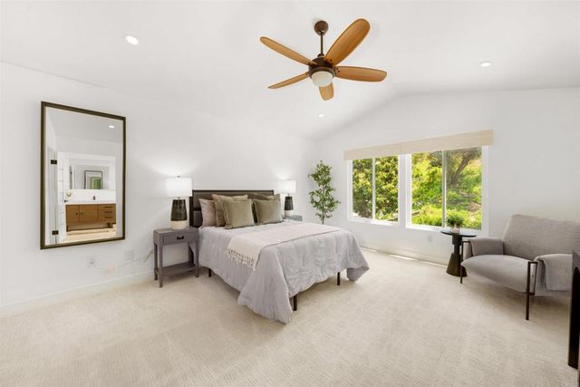 a bathroom with a tub sink a mirror and shower