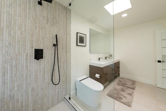 a bathroom with a double vanity sink a mirror and shower