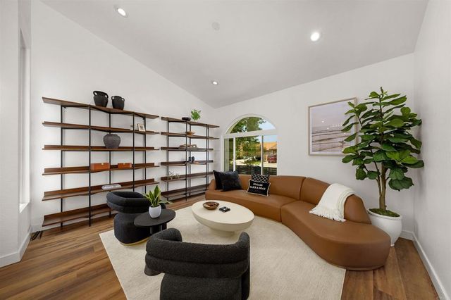 a living room with furniture and a potted plant
