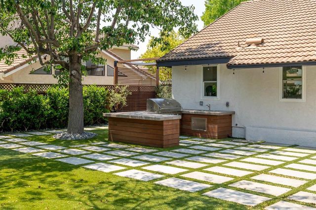 a view of a porch with furniture and a yard