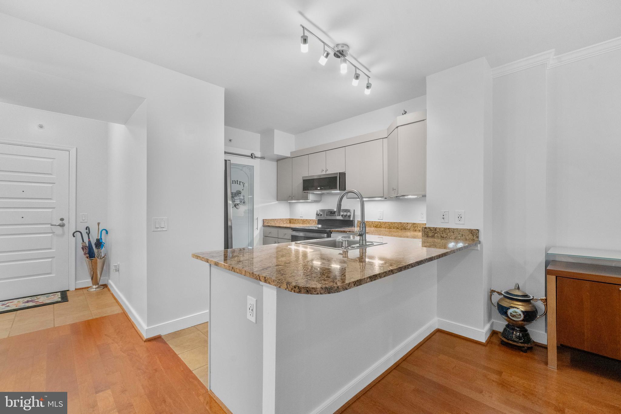 616 E Street Northwest, Unit 522 Washington, DC 20004 - Photo 11 of 43 a kitchen with stainless steel appliances granite countertop a sink stove and refrigerator