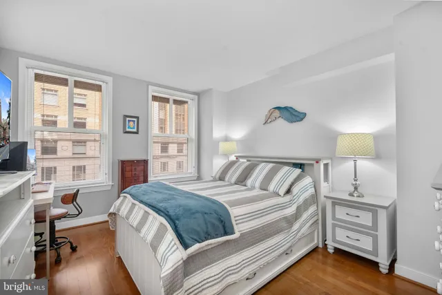 a spacious bedroom with a bed and a desk