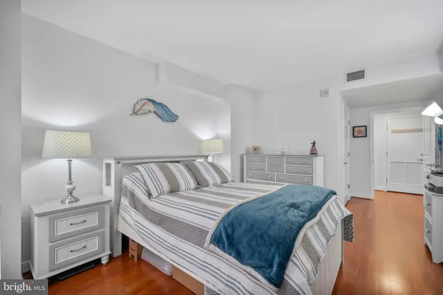 a spacious bedroom with a bed and cabinet