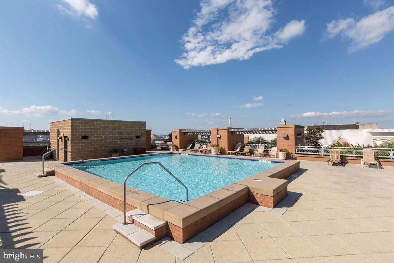 616 E Street Northwest, Unit 522 Washington, DC 20004 - Photo 24 of 43 a living room with furniture and a flat screen tv