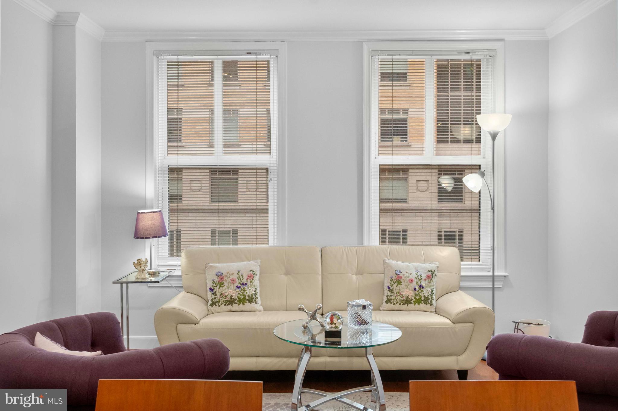616 E Street Northwest, Unit 522 Washington, DC 20004 - Photo 7 of 43 a living room with furniture and windows