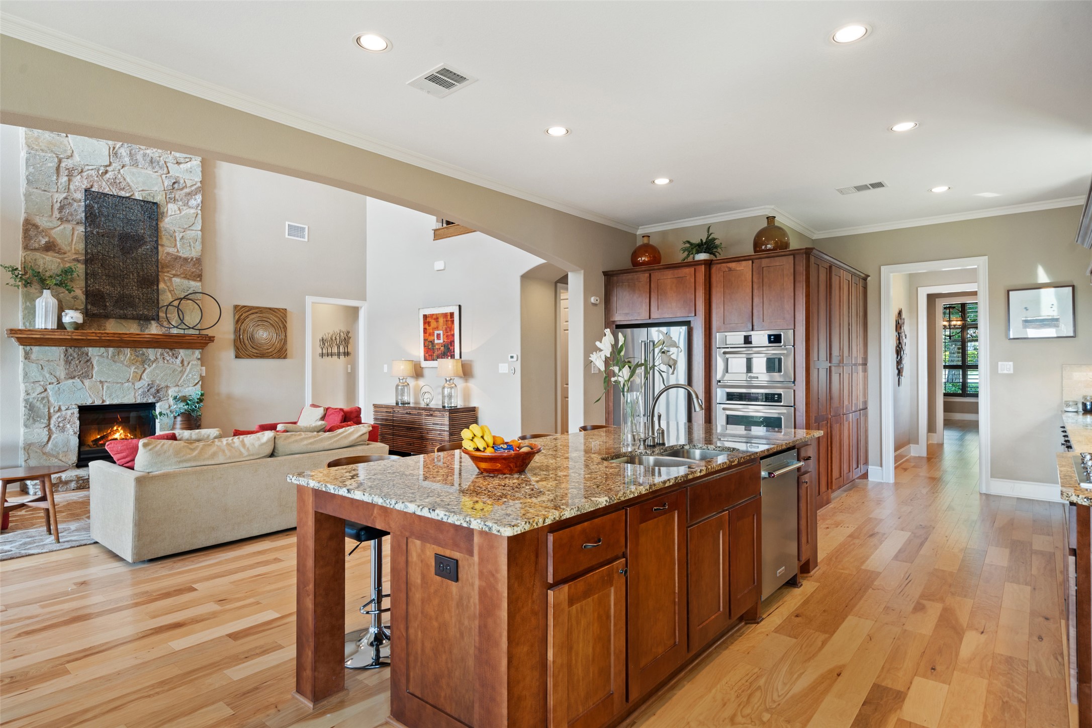 732 SANTALUZ Path Austin, TX 78732 - Photo 14 of 40 a open kitchen with kitchen island granite countertop wooden floors granite top and stainless steel appliances