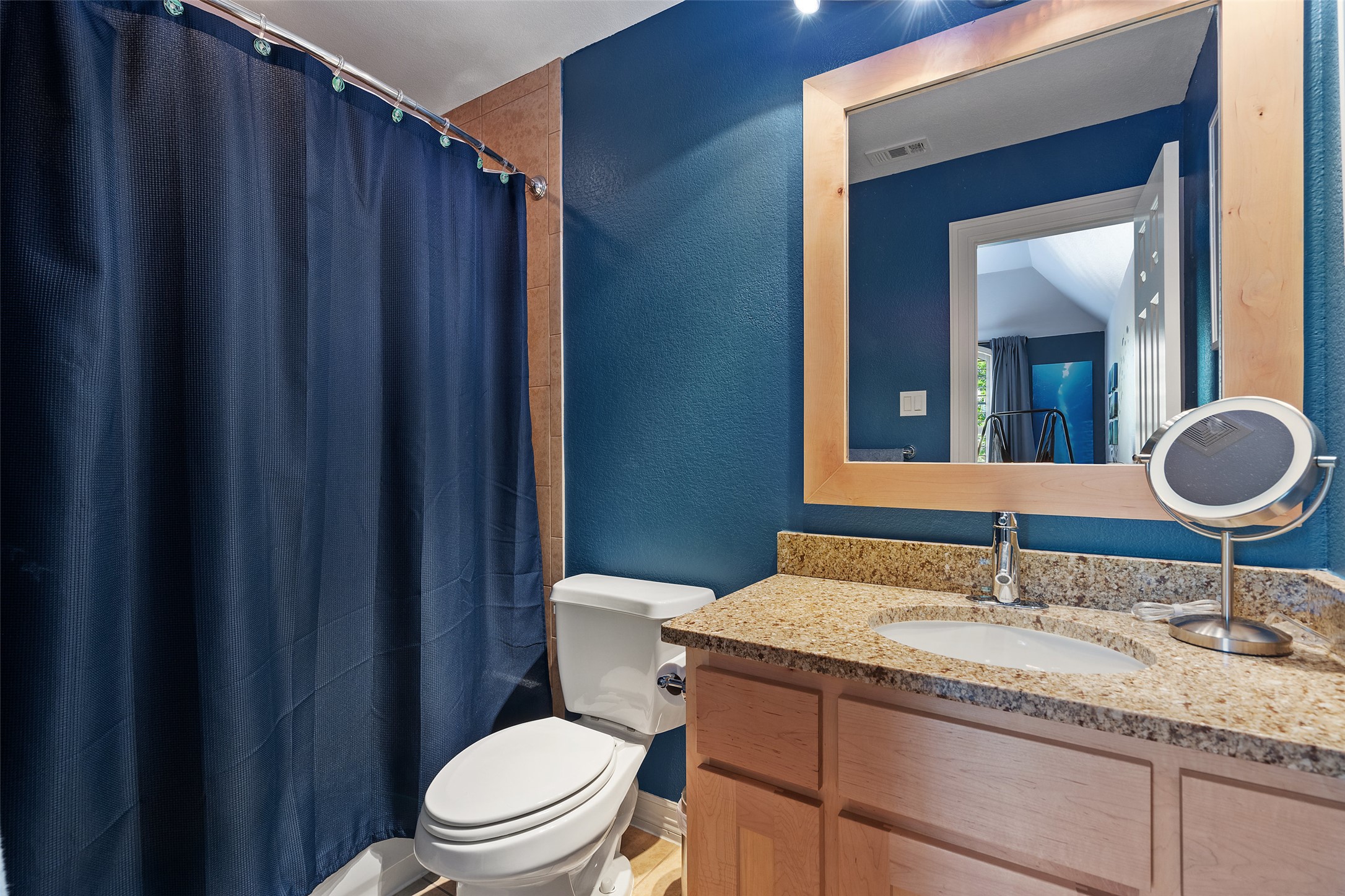 732 SANTALUZ Path Austin, TX 78732 - Photo 26 of 40 a bathroom with a granite countertop sink a toilet and mirror