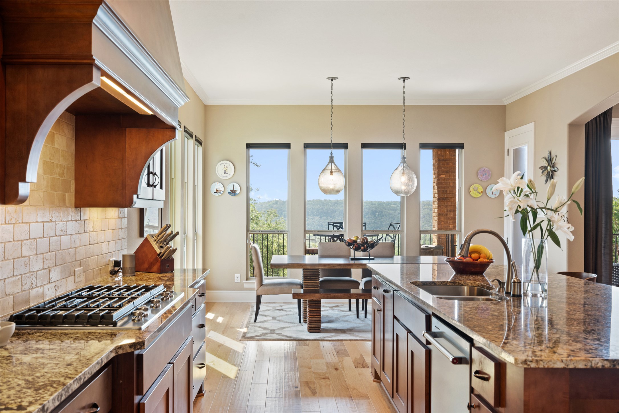 732 SANTALUZ Path Austin, TX 78732 - Photo 4 of 40 a kitchen with a stove a sink and a wooden cabinets