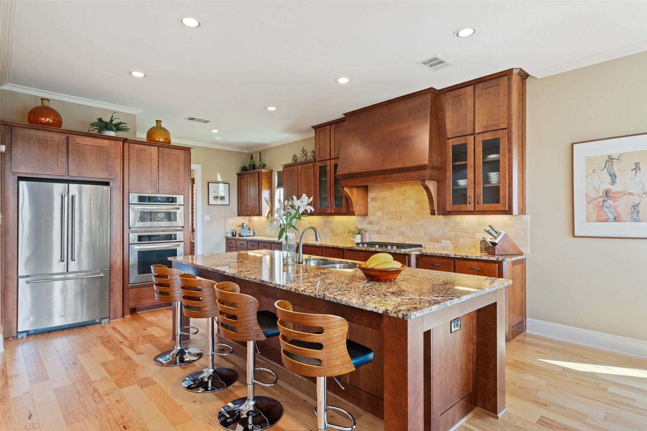 732 SANTALUZ Path Austin, TX 78732 - Photo 6 of 40 a kitchen with stainless steel appliances granite countertop a kitchen island a stove a refrigerator a sink a dining table and chairs with wooden floor