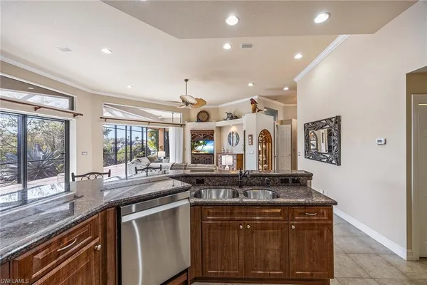 a dining room with furniture a chandelier and window