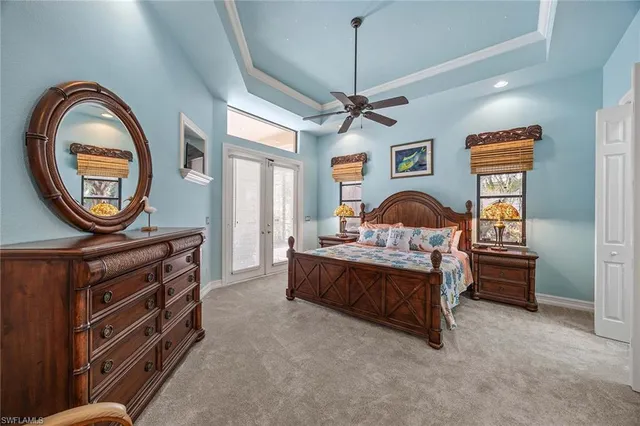 a bedroom with furniture and a large window
