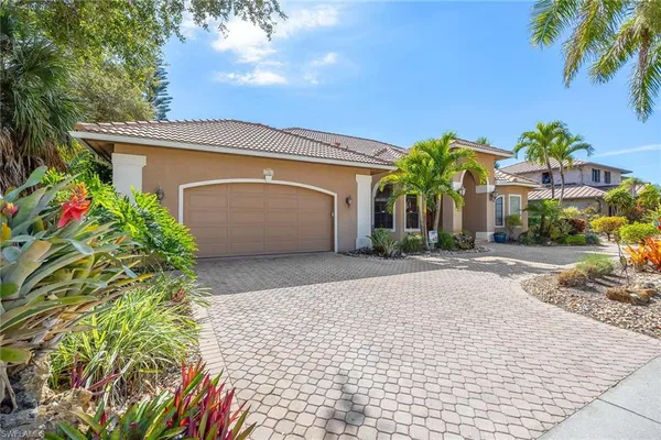 a front view of a house with a yard and a garage