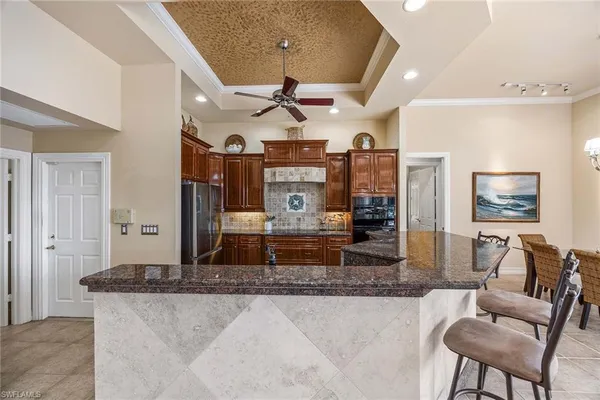 a kitchen with stainless steel appliances granite countertop a refrigerator and a stove