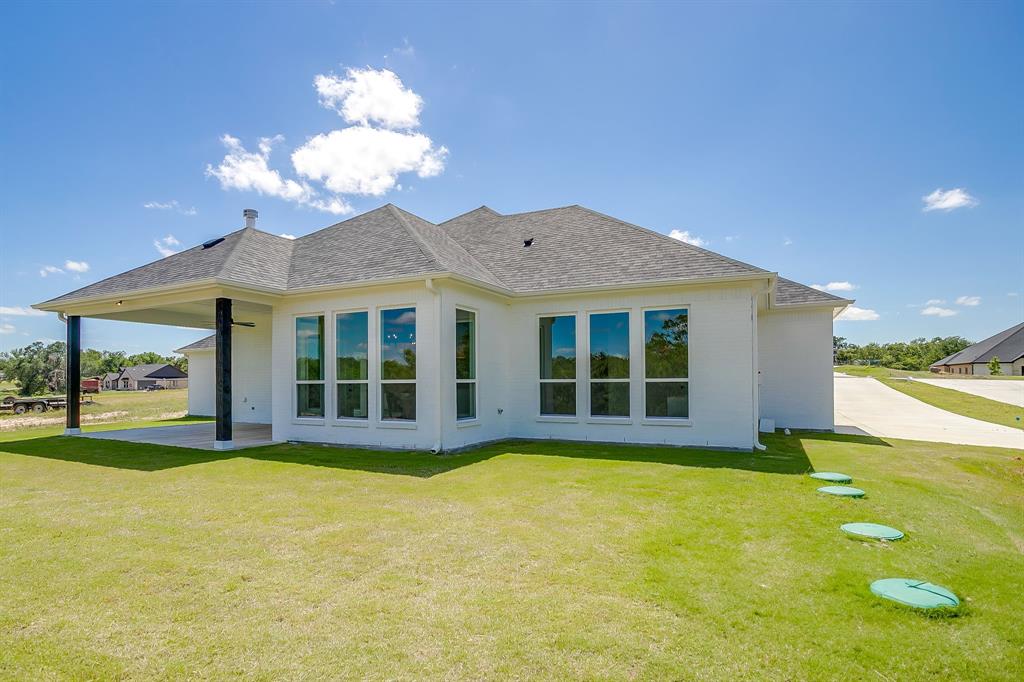 9012 Valley Oak Court Springtown, TX 76082 - Photo 38 of 40 a view of a house with a yard and potted plants