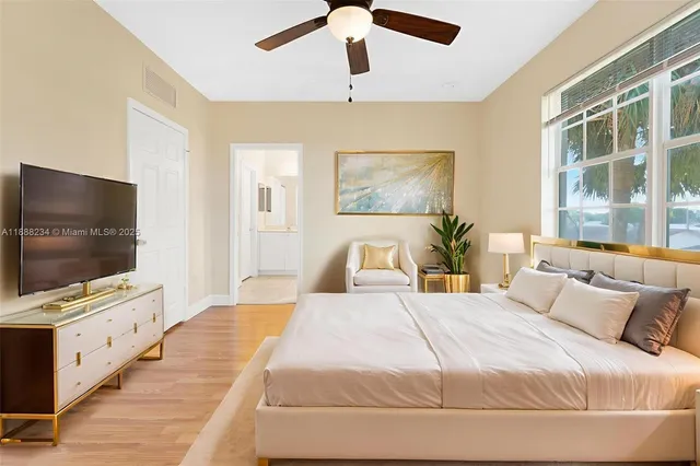 a bedroom with a bed and a flat screen tv