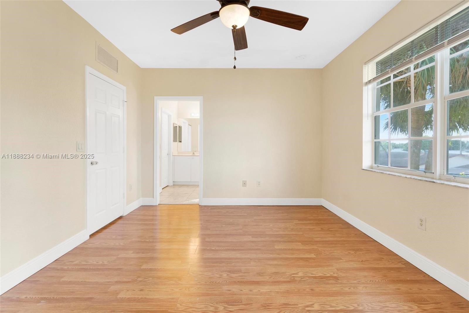 2508 Southwest 85th Terrace, Unit 105 Miramar, FL 33025 - Photo 15 of 27 a view of an empty room with wooden floor and a window