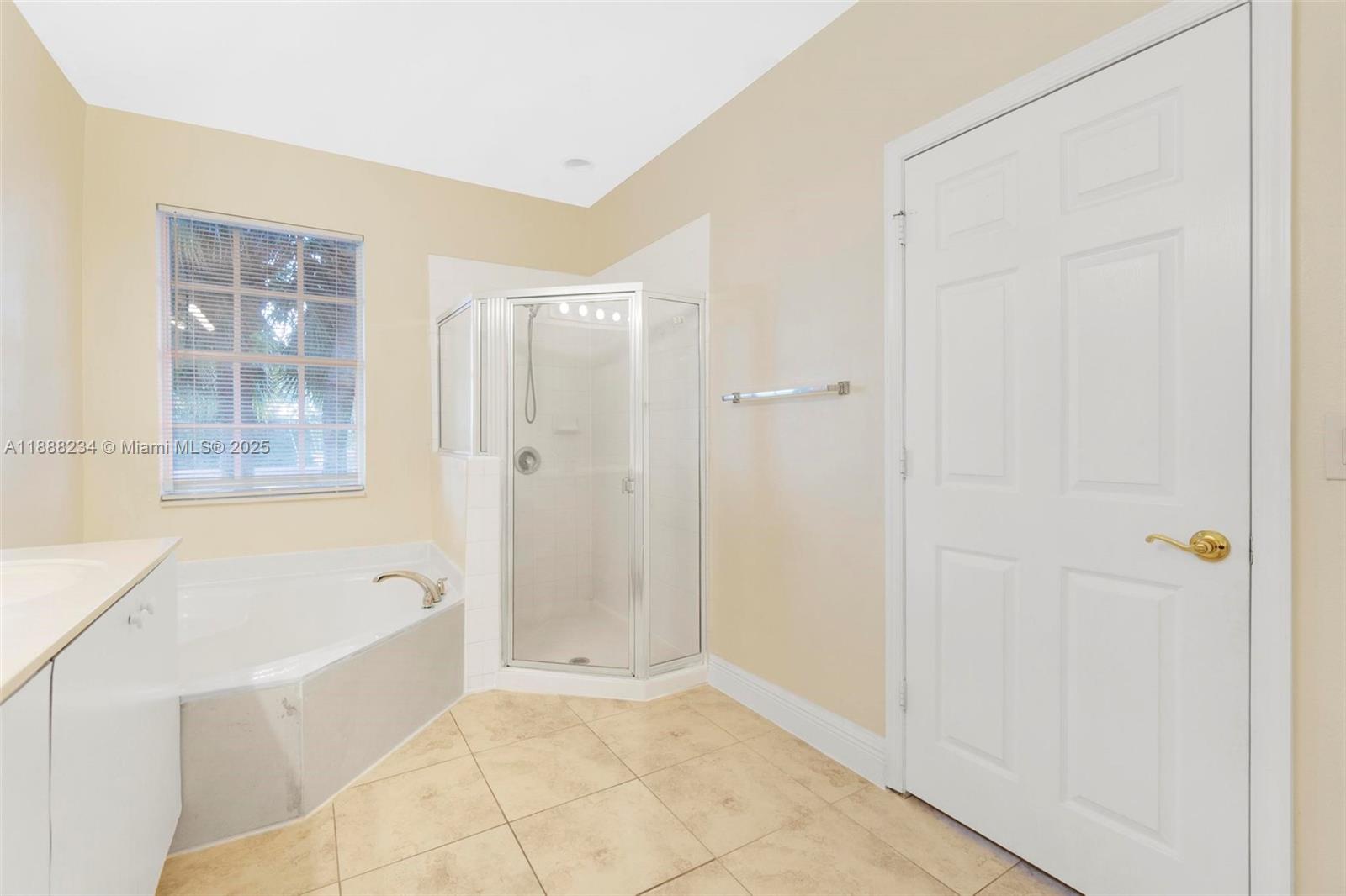 2508 Southwest 85th Terrace, Unit 105 Miramar, FL 33025 - Photo 16 of 27 a bathroom with a bathtub and shower