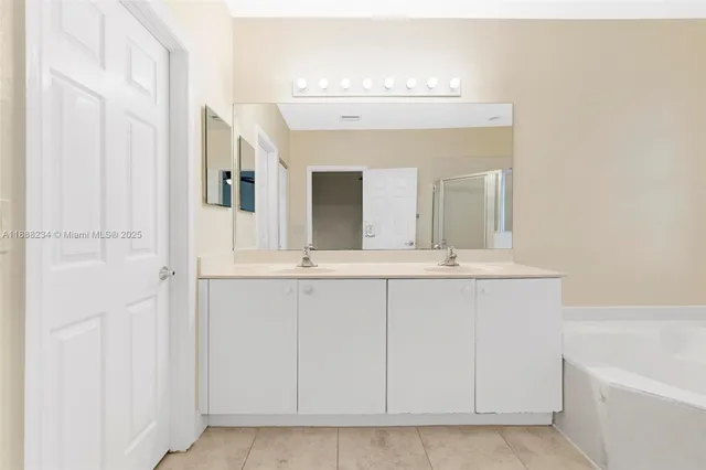 a bathroom with a sink vanity and a mirror