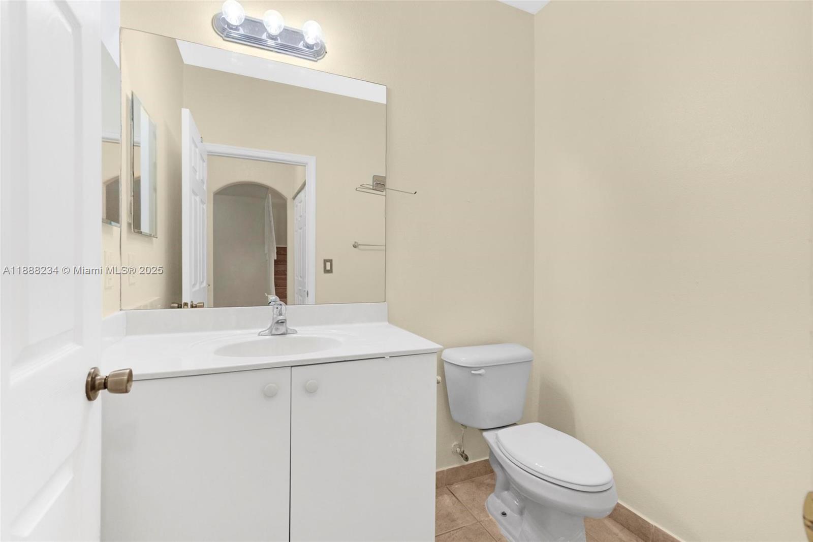 2508 Southwest 85th Terrace, Unit 105 Miramar, FL 33025 - Photo 24 of 27 a bathroom with a toilet a sink and mirror