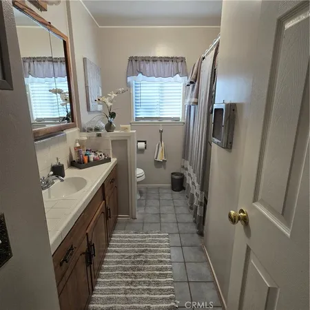 a bathroom with sink a washing machine and a shower