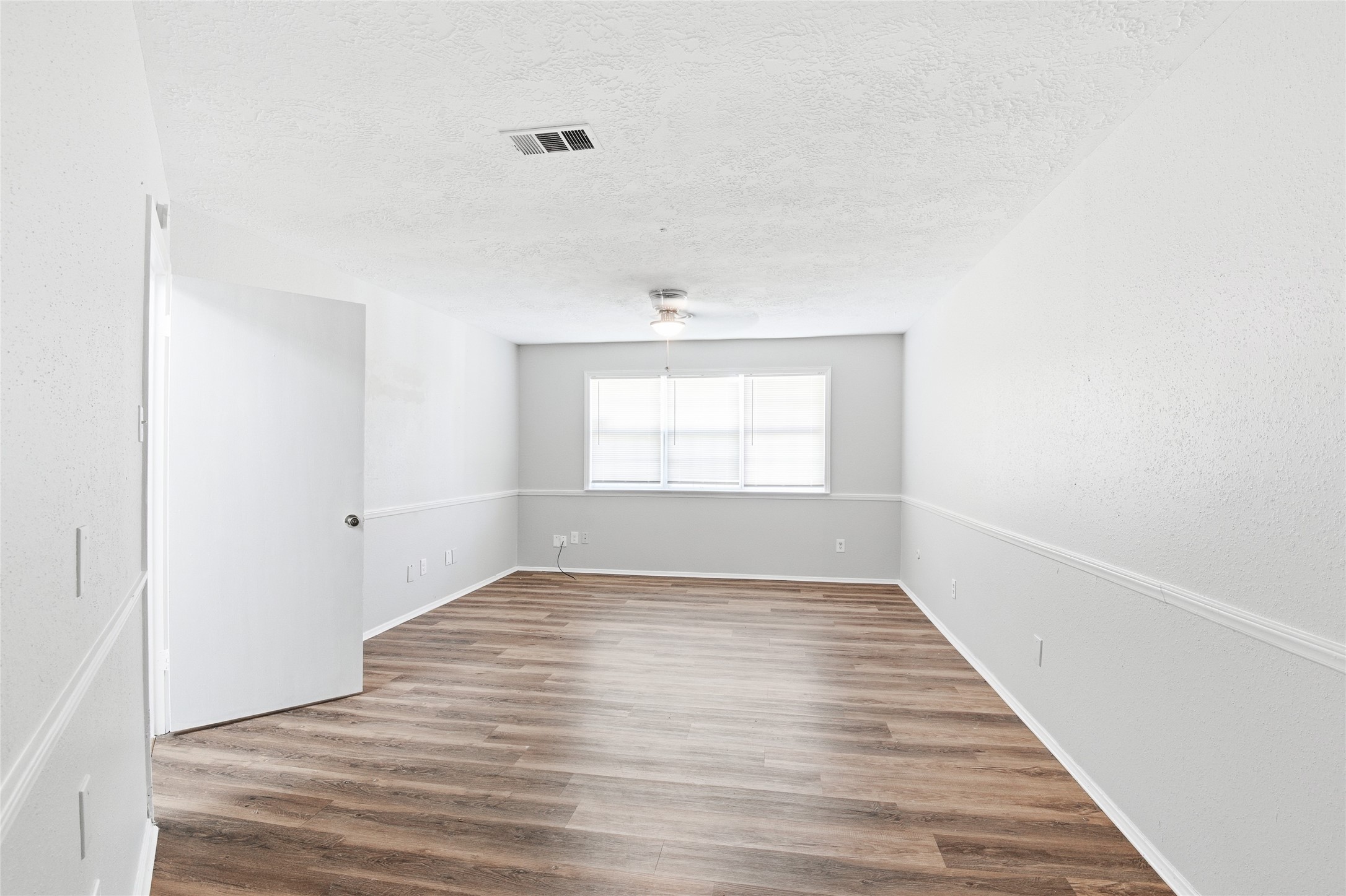 6519 Bridgegate Drive Spring, TX 77373 - Photo 13 of 23 a view of an empty room with wooden floor and a window