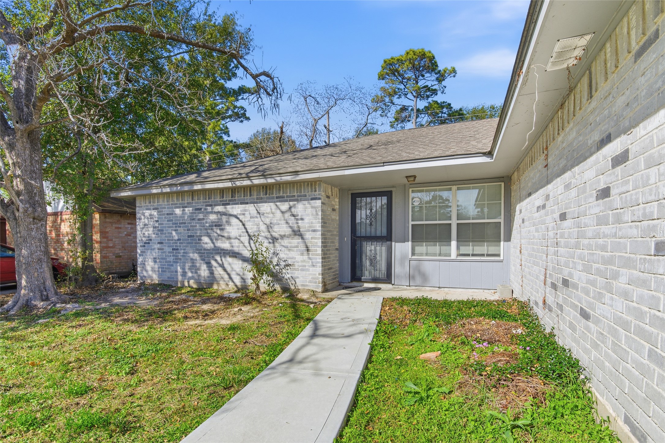 6519 Bridgegate Drive Spring, TX 77373 - Photo 2 of 23 a view of a house with a small yard plants and large tree