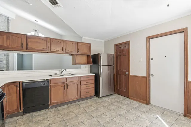 a kitchen with stainless steel appliances granite countertop a refrigerator and a sink