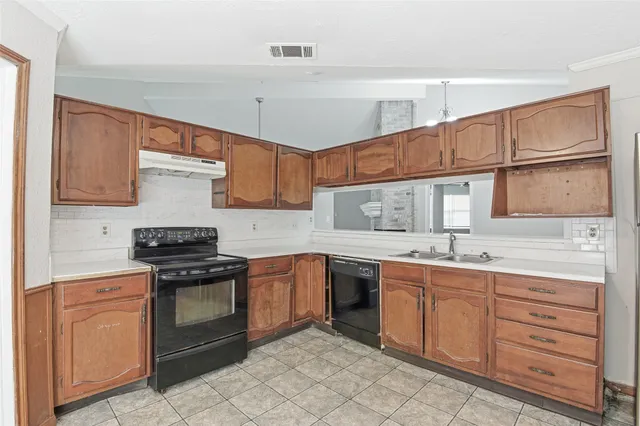 a kitchen with a sink stove and cabinets