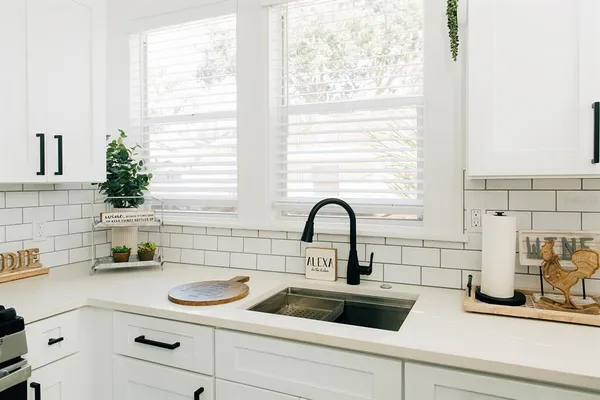 a kitchen with a sink cabinets and window