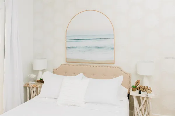 a spacious bedroom with a bed and a window