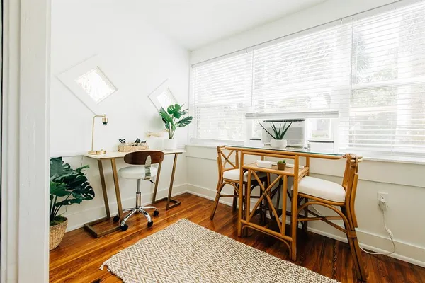 a view of a dining room with furniture and a window