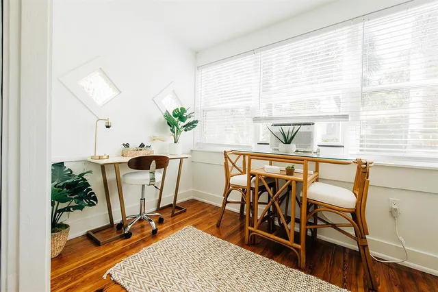 a view of a dining room with furniture and a window