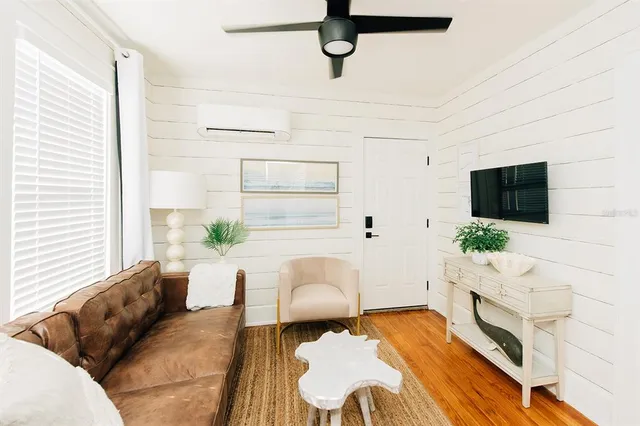 a living room with furniture and a flat screen tv