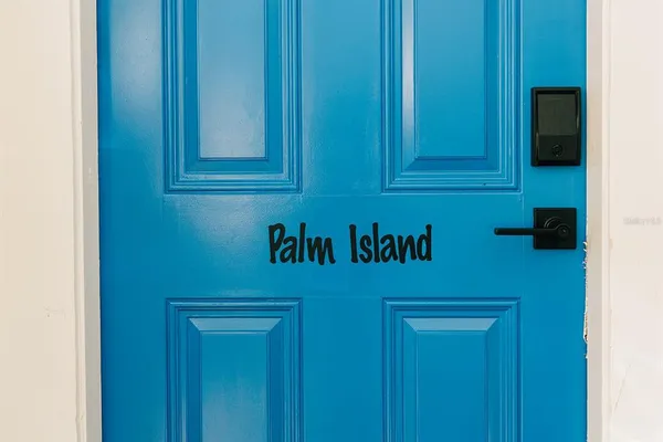 a view of a chair and table in backyard of the house